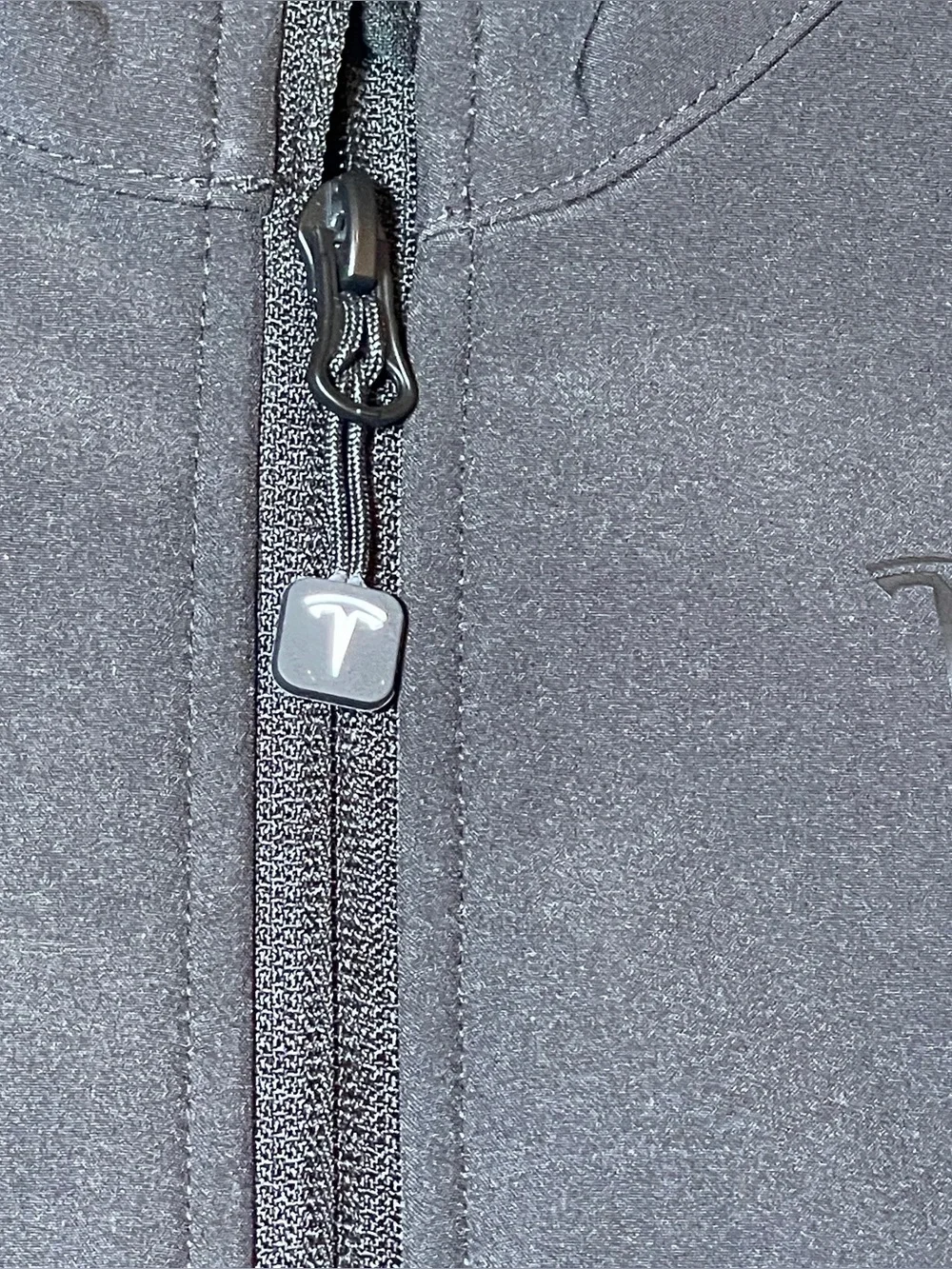 TESLA -The image features a Tesla Kids Corporate Softshell Jacket, black